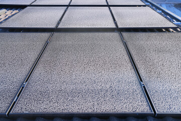 Frost pattern on photovoltaic modules on a cold sunny day in winter