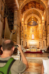 Man Taking Picture In the Cathedral of Monreale Decorated With Gold Mosaic In sicily