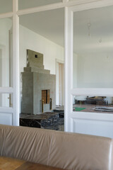 The process of finishing a fireplace in an old house during major repairs. The marble is black with white veins.