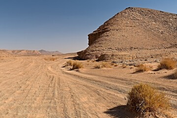 View of the Tadrart Rouge rocky mountain range in Tassili n Ajjer National Park. Sahara desert, Algeria, Africa.