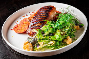 Roasted Duck breast fillets with vegetable salad and batat in plate