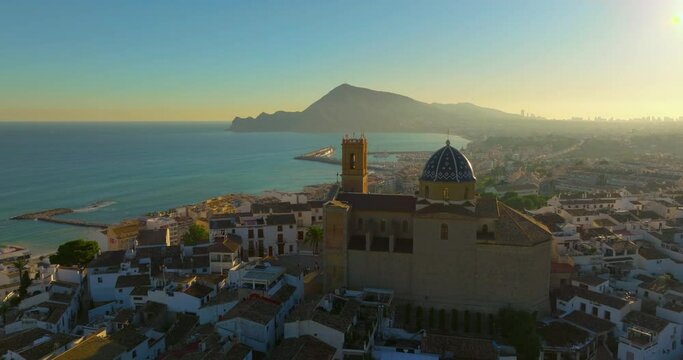Aerial view of the city of Altea and the picturesque Mediterranean coast. Spain. An ancient Catholic church on the mountain as a landmark of the city of Altea
