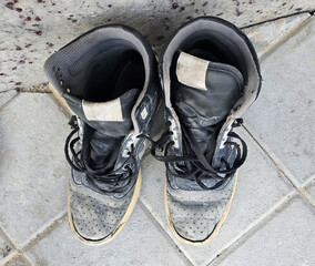 A pair of beautiful old boots, weathered with time, tells a story of countless journeys. Their worn leather exudes character, with creases and scuffs that add to their timeless charm. The rugged soles