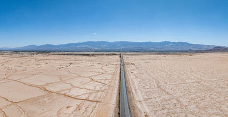 Classic panorama view of an endless straight road running through the barren scenery of the...