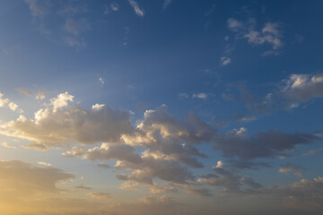 Naklejka na ściany i meble Beautiful blue sky with white clouds lit by the sun.