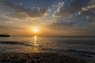 Obraz premium Landscape by the sea in Greece on the island of Rhodes. Sunrise, dramatic clouds. Beautiful background.