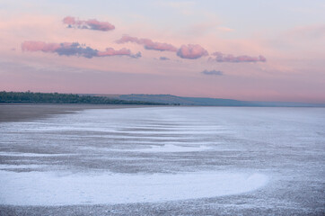 Salty dry lake at sunset. Ecological problem. Global climate change and warming.
