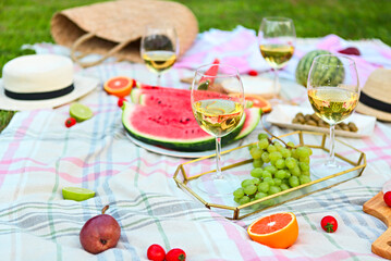 Picnic with white wine on green grass