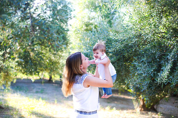 Fototapeta premium Young beatiful woman with baby outdoors