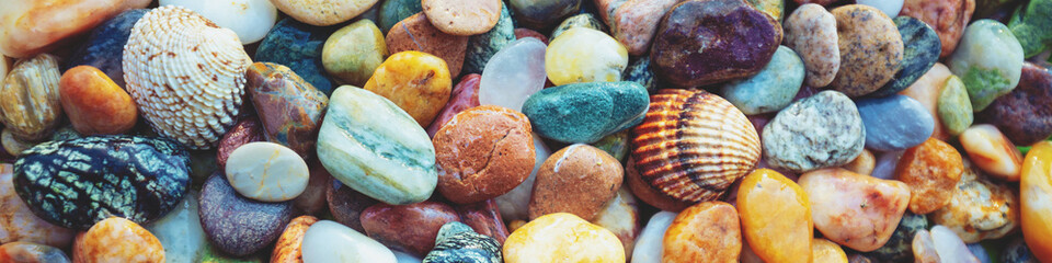 Abstract nature pebbles background. Colorful pebbles texture. Stone background. Sea pebble beach. Beautiful nature. Horizontal banner - obrazy, fototapety, plakaty