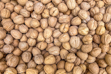 Walnuts background. Texture of walnuts in top view