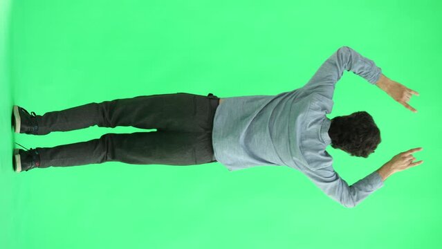 man in full growth. isolated on green background jumping rejoices