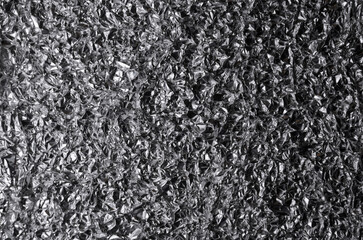 Silver metallic crumpled aluminum foil background