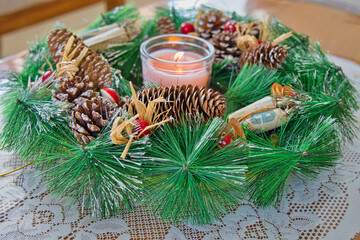 Christmas and new year season, candle between fir sprig,candle, cones and red mushroom heads