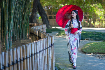 Pretty the Traveller Young Asian woman wearing a Japanese traditional kimono dress, a Yukata dress,...
