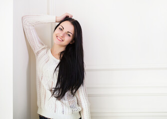 Happy cute teen girl near the wall in the room