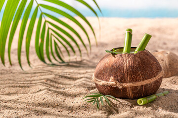 Fresh pinacolada in coconut served on a sandy island.