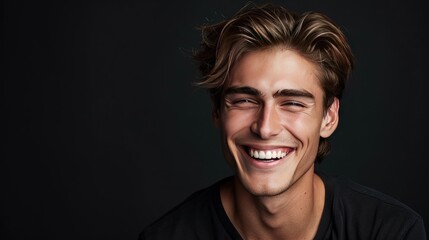Obraz premium Handsome young smiling man black background
