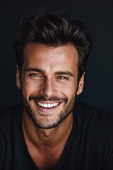 Fototapeta premium Handsome young smiling man black background