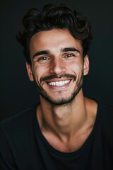 Obraz premium Handsome young smiling man black background