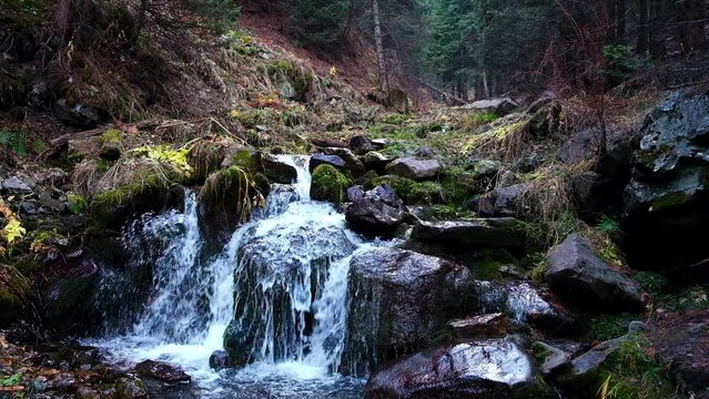 Waterfall on a small mountain river in the forest. Ayusai gorge in Almaty Kazakhstan, Tien Shan mountain system, Trans-Ili Alatau ridge.