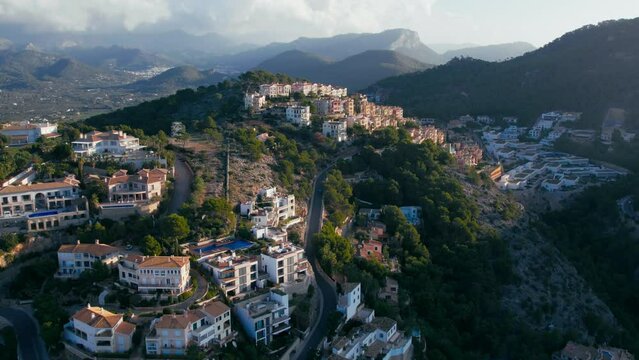Exclusive and luxurious real estate in port d'andratx, Mallorca, Spain. Aerial of expensive private villas on Mediterranean Coast. Illegal development of park land on the shore
