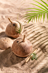 Fresh coconut milk in shell on a tropical beach.