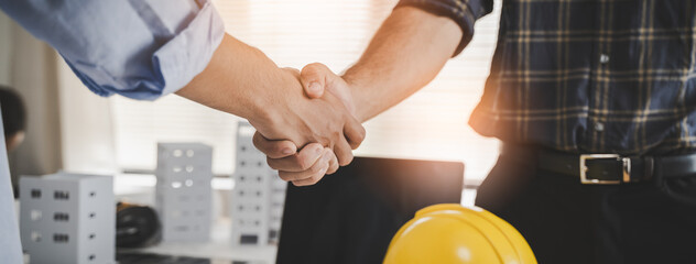 construction worker and contractor. Client shaking hands with team builder in renovation site. - obrazy, fototapety, plakaty