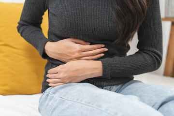 close up woman suffering stomach pain from food poisoning.