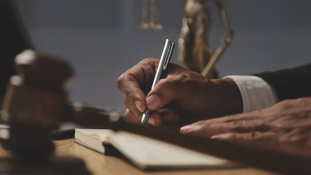 justice and law concept.Male judge in a courtroom on wooden table and Counselor or Male lawyer working in office. Legal law, advice and justice concept.