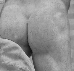 sculpted backside of the marble statue in detail seen from behind