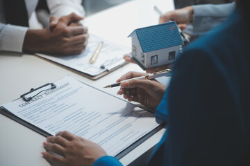 Real estate agent and customer signing contract to buy house, insurance or loan real estate.rent a house,get insurance or loan real estate or property.
