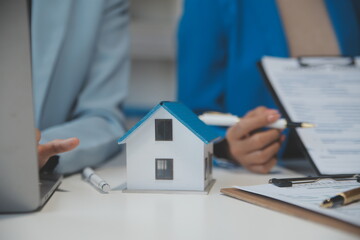 Real estate agent and customer signing contract to buy house, insurance or loan real estate.rent a house,get insurance or loan real estate or property.