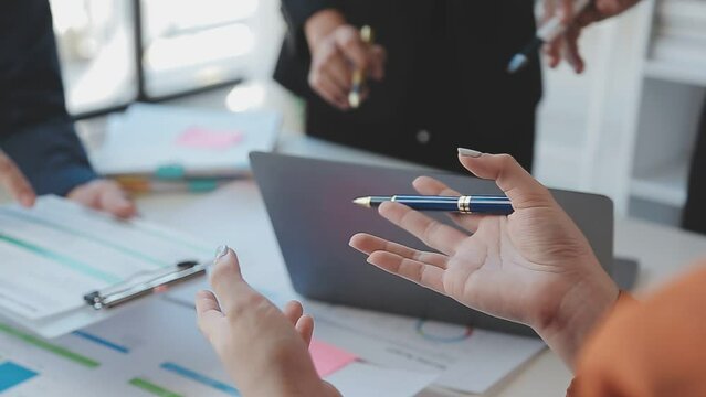 Close-up asia business people meeting plan analysis statistics brainstorm and header of team hold tablet pointing graph chart and employee take note. Finance strategy statistics success concept.