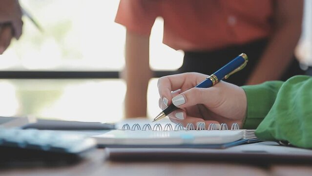 Close-up asia business people meeting plan analysis statistics brainstorm and header of team hold tablet pointing graph chart and employee take note. Finance strategy statistics success concept.