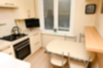 Blurred kitchen in beige tones.