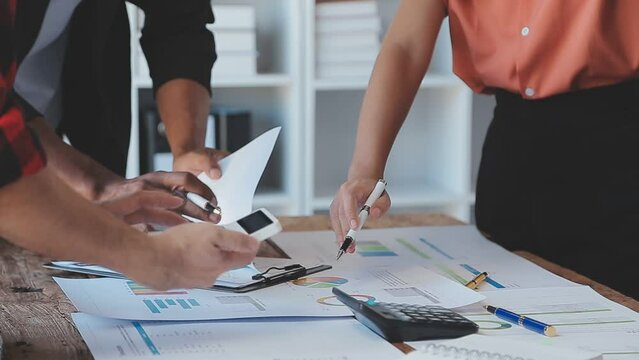 Close-up asia business people meeting plan analysis statistics brainstorm and header of team hold tablet pointing graph chart and employee take note. Finance strategy statistics success concept.