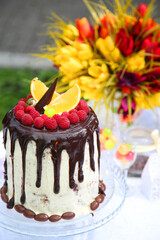 Birthday party for children. A festive table decorated with birthday cake with flowers and sweets.