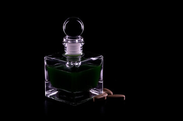 stylish bottle of perfume on black with  pills