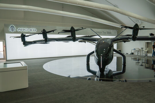 Archer Aviation Midnight eVTOL aircraft on display at Dubai Airshow November 13th 2023, dark colors, bright background, indoors. Electric aircraft, electric helicopter.