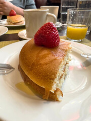 sliced pancake with fresh strawberry fruit on plate