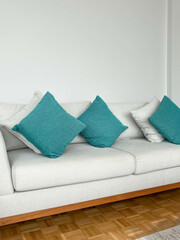 new sofa with small green pillows in a living room