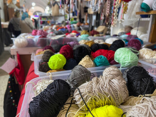 heap of colorful yarn balls in knitting shop