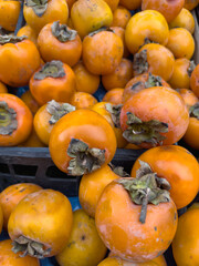 fresh ripe persimmon fruit on grocery market