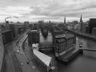 The Speicherstadt in Hamburg. Warehouses that are World Heritage. Connected by 8 bridges. Landmark and touristic attraction. Birds eye aerial drone view.