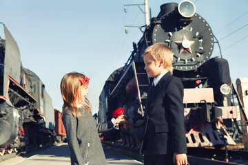 little boy and little girl near the trains