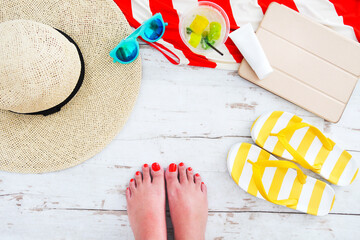 Beach accessories on white wooden background