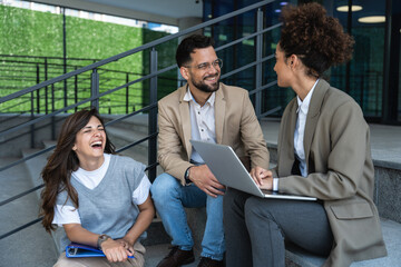Group of young business people product strategy experts waiting for staff meeting with employer from human resources for job search in front of office building. Businessmen and businesswomen discuss