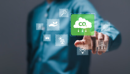 Reduce CO2 emissions concept. Person touch virtual carbon reduction icons for climate change to...