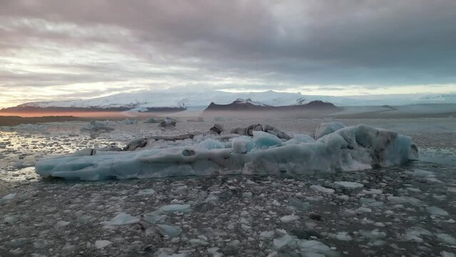 Spectacular drone aerial view of Iceland's largest glacier and a beautiful sunset over a huge glacial mass and reflecting on a glacial lake, Jokulsarlon and Vatnaj&ouml;kull gracier, Iceland